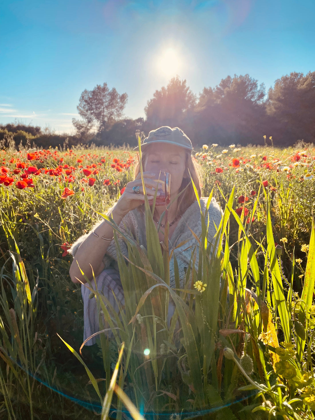 A man standing in a sunlit meadow at golden hour